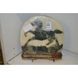 An unusual carved stone plaque depicting a prancing horse.
