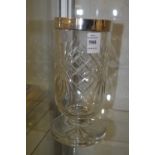 A cut glass celery vase withsilver rim.