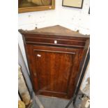 A 19th century oak hanging corner cupboard.