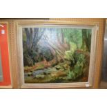 A wooded river landscape, oil on canvas, in a gilt frame.