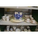 Three shelves of decorative and household china.