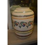 A large colourful pottery vase.