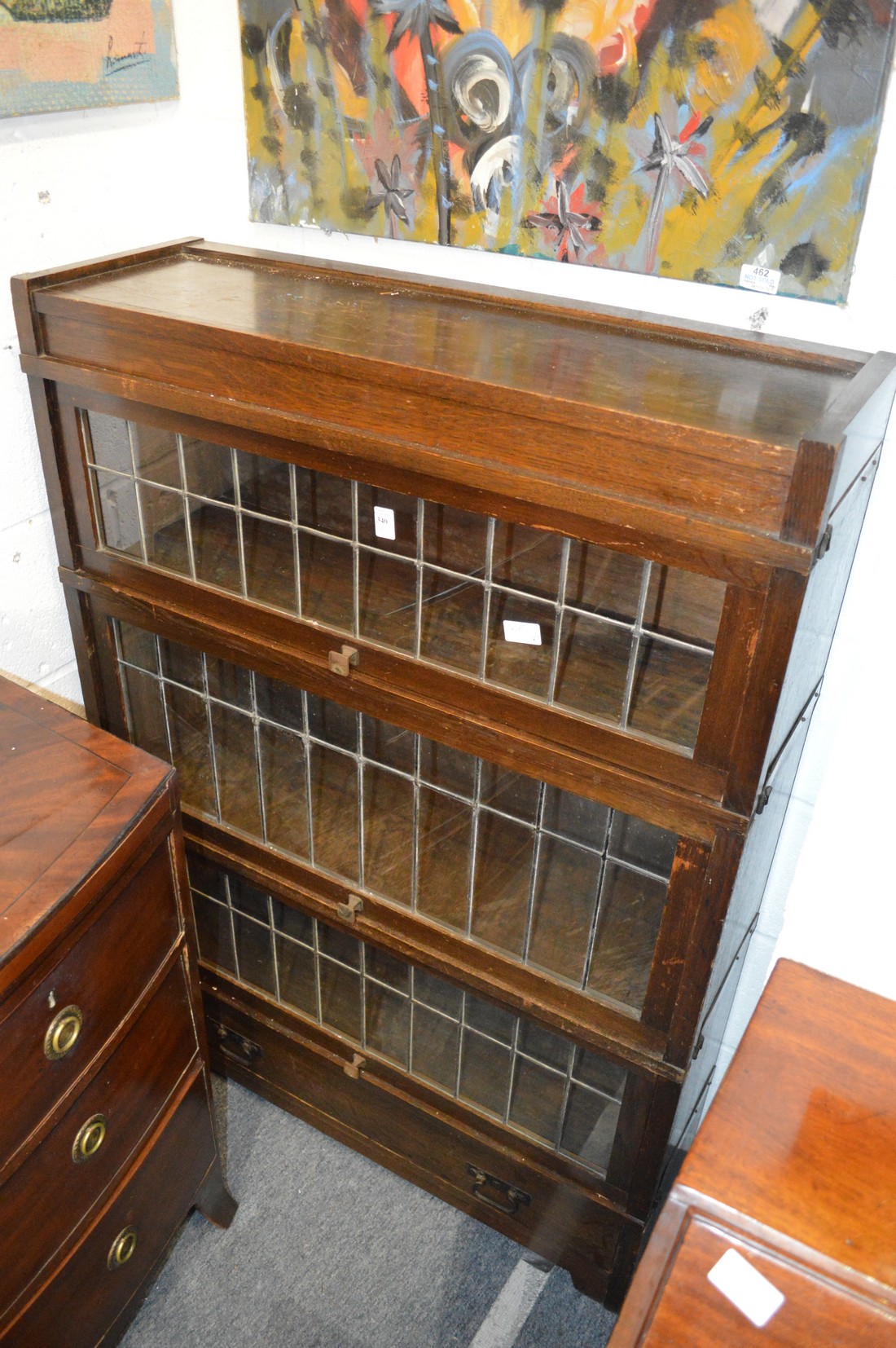 An oak Globe Wernicke three section bookcase with a drawer to the base.