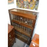 An oak Globe Wernicke three section bookcase with a drawer to the base.