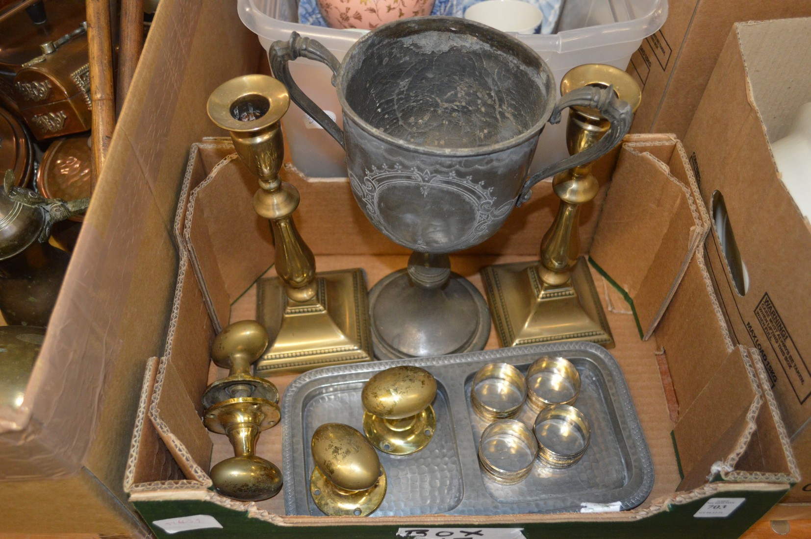 A pair of brass candlesticks, a pewter cup etc.