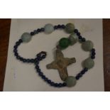 A Roman bronze cross on a bead necklace.