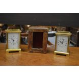 Two brass carriage clocks and an old carriage clock case.