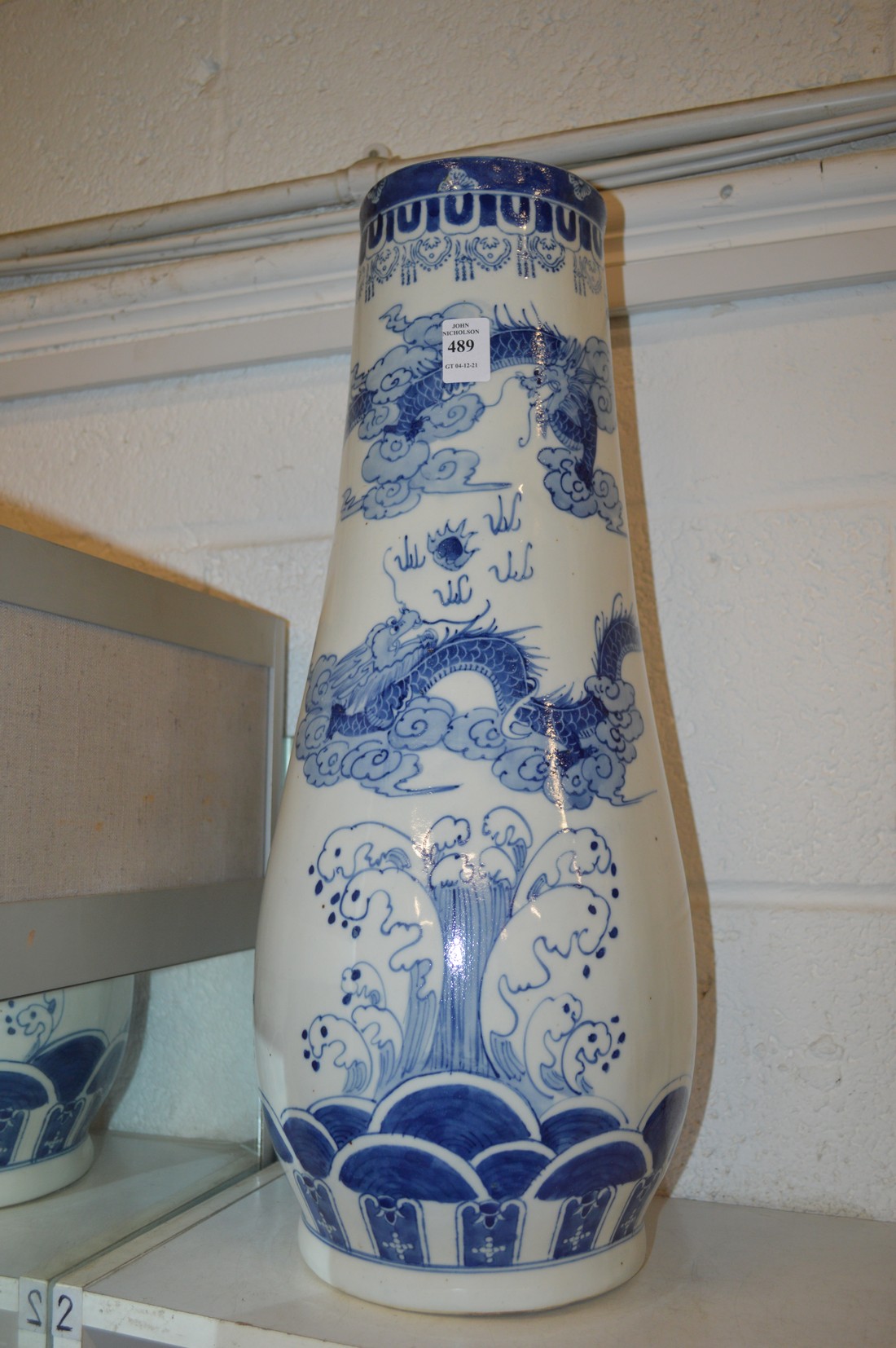 A large Chinese blue and white tapering vase or stick stand.