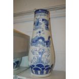 A large Chinese blue and white tapering vase or stick stand.