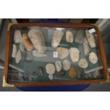 A mahogany display case containing a good collection of stone axes, flint spear and arrow heads