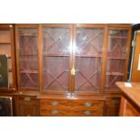 A George III style mahogany and satinwood inlaid breakfront library bookcase.