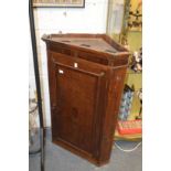 A 19th century oak hanging corner cupboard.