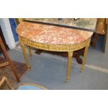 A good giltwood demi-lune console table with classical decoration and variegated rouge marble top.