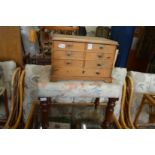 A small pine table top chest and a stool.