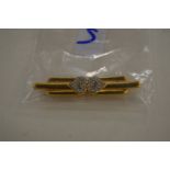 A decorative bar brooch, signed Monet.