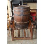 A large milk churn on stand.