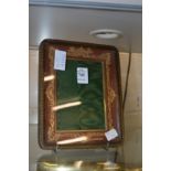 A gilt embossed leather photograph frame.