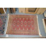 A small rust ground Bokhara rug.