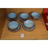 A set of five Chinese bowls with matching stands.