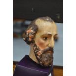 A painted plaster bust of a saint.