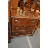 A walnut three drawer chest.