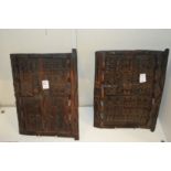 A pair of African carved wood small doors.
