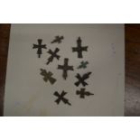 A collection of small Roman bronze crosses.
