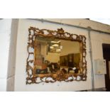 A decorative Florentine framed wall mirror.