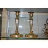 A pair of Adam revival plated candlesticks.