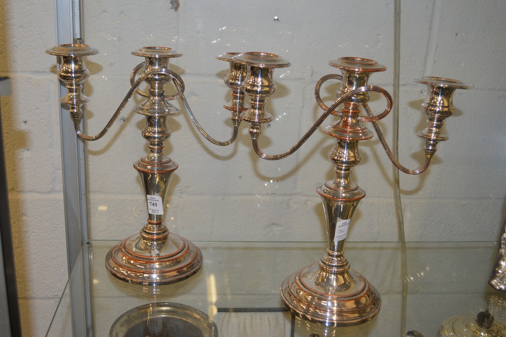 A pair of Old Sheffield Plate three light twin branch candelabra.