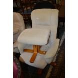 A modern beige cloth upholstered reclining revolving armchair with matching stool.