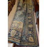 A large Persian style blue ground carpet.