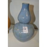 A Chinese pale blue glazed gourd shaped vase.