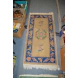 A small beige ground Chinese rug.