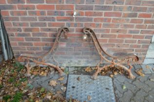 A pair of heavy cast iron garden bench ends.