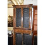 A Regency design rosewood floor standing, two part, four door bookcase, the brass grilled doors