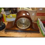 A mahogany mantle clock.