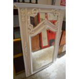 A white painted over mantle mirror.