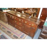 An 18th century oak dresser with three central graduated drawers flanked by a further pair of