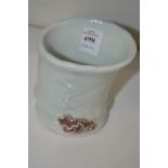 A small porcelain bamboo form brush pot.