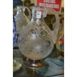 A good engraved and cut glass ewer or jug with silver mounted base.