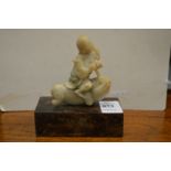 A 19th century Chinese carved soapstone small figure of a boy riding a beast.