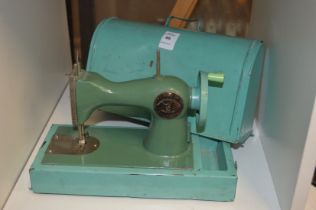 A child's tin plate sewing machine