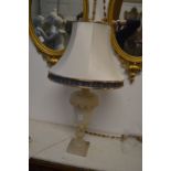 A carved alabaster urn shaped table lamp.