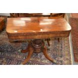 A 19th century mahogany D-shaped foldover card table on a fluted column support with four outswept