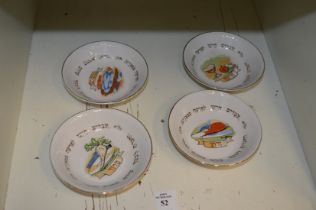 Four small porcelain dishes.