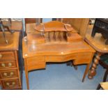 A Sheraton revival inlaid mahogany serpentine fronted writing table.