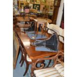 A Victorian walnut extending dining table with one leaf on turned and reeded legs.