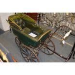 An unusual early Victorian pram with wooden wheels.