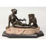 A BRONZE DECO NUDE on a marble base. 10ins long.